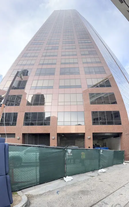 hise rise building in LA with temporary fencing around it